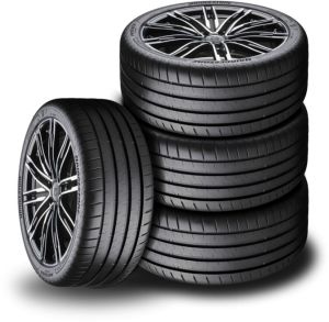 Vier gestapelte Autoreifen mit Felgen.